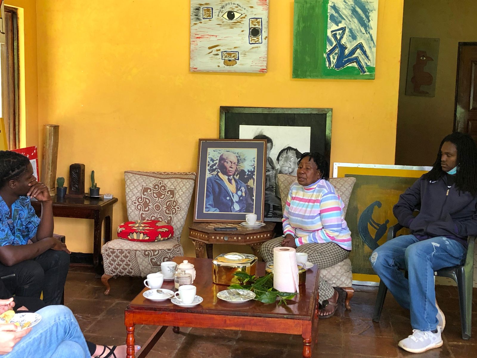 Guests sharing tea and stories in the Riara farmhouse
